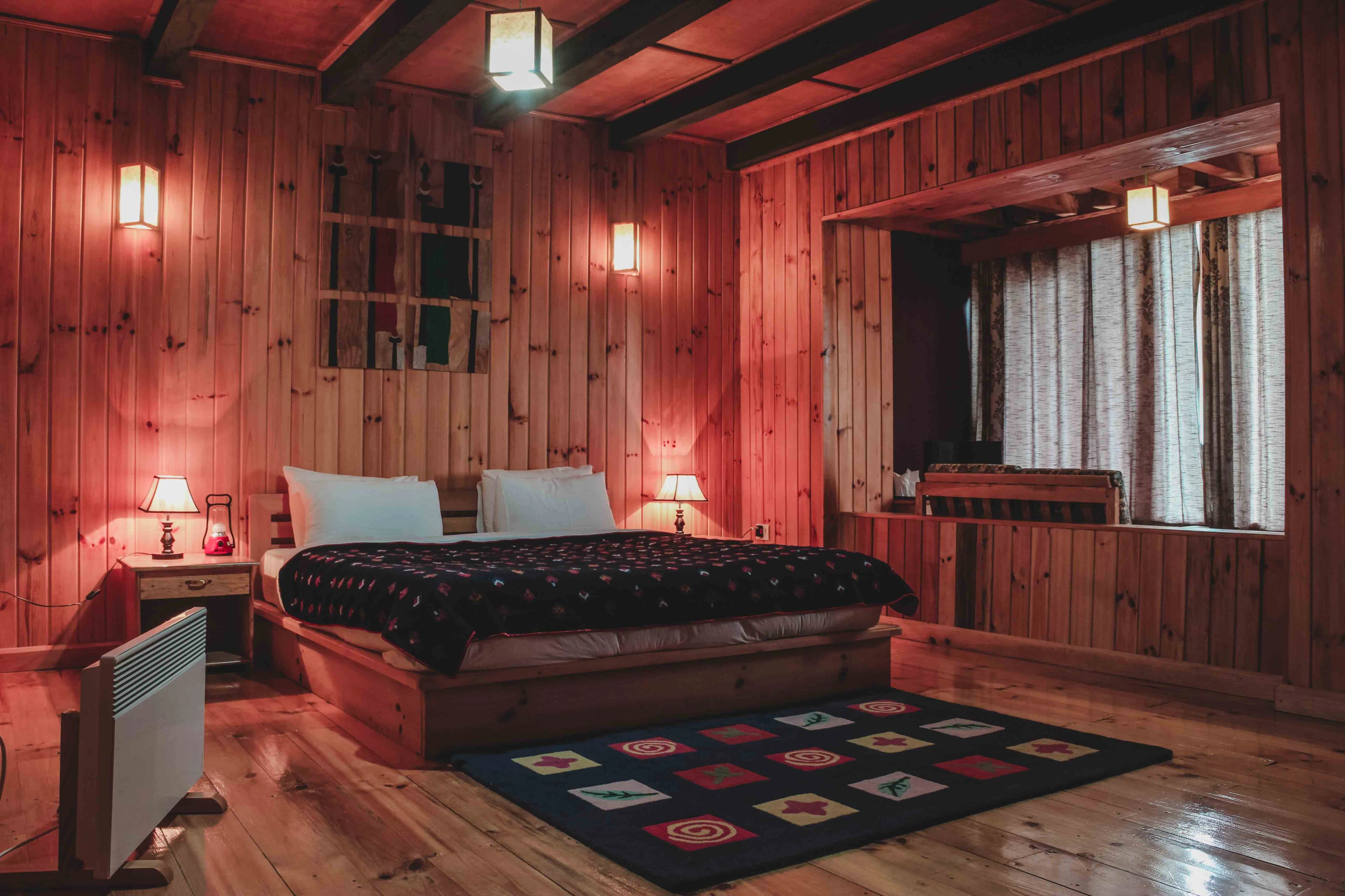 A shot of the queen sized bed and the lounge area in the background