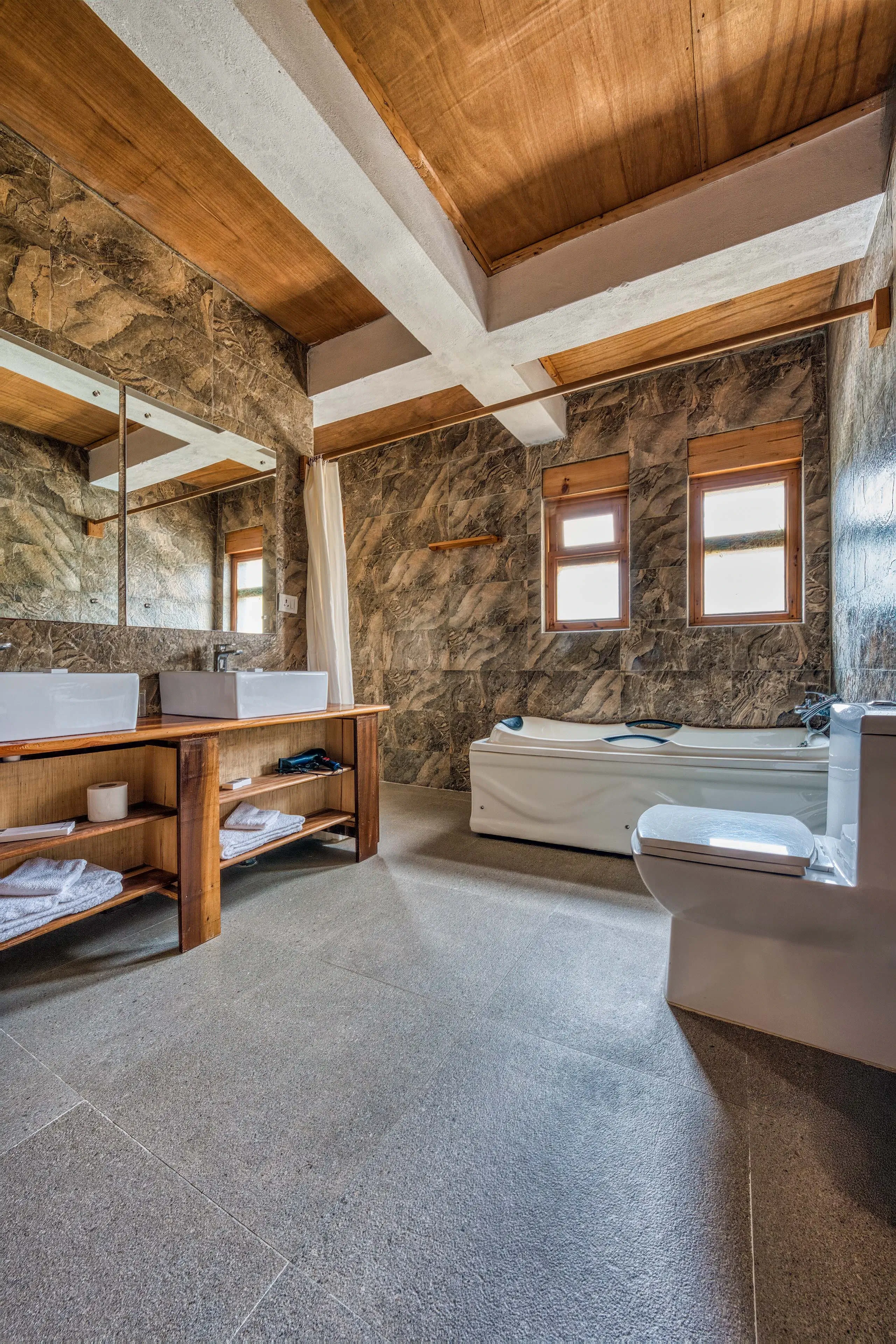 A fish eye shot of the bathroom featuring the bathtub and the sink
